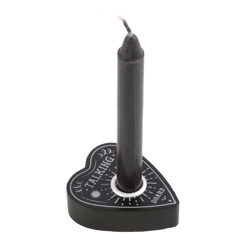 Black talking board planchette-shaped spell candle holder with a black spell candle, featuring sun and celestial engravings