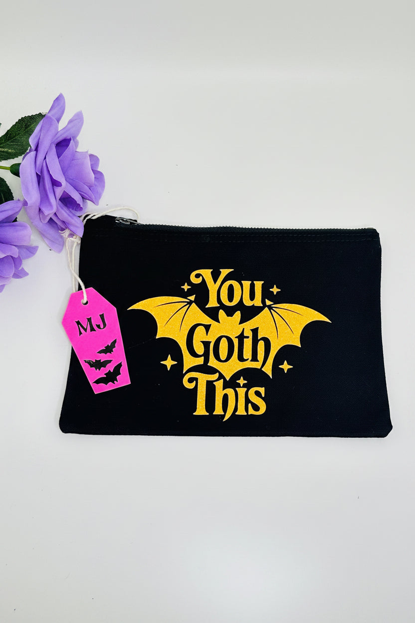 You Goth This gothic makeup bag with black base and orange glitter accents