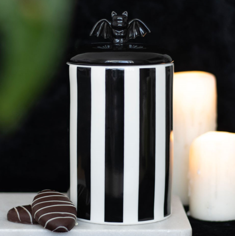 Black-and-white striped ceramic bat storage jar with a lift-off bat-detail lid.
