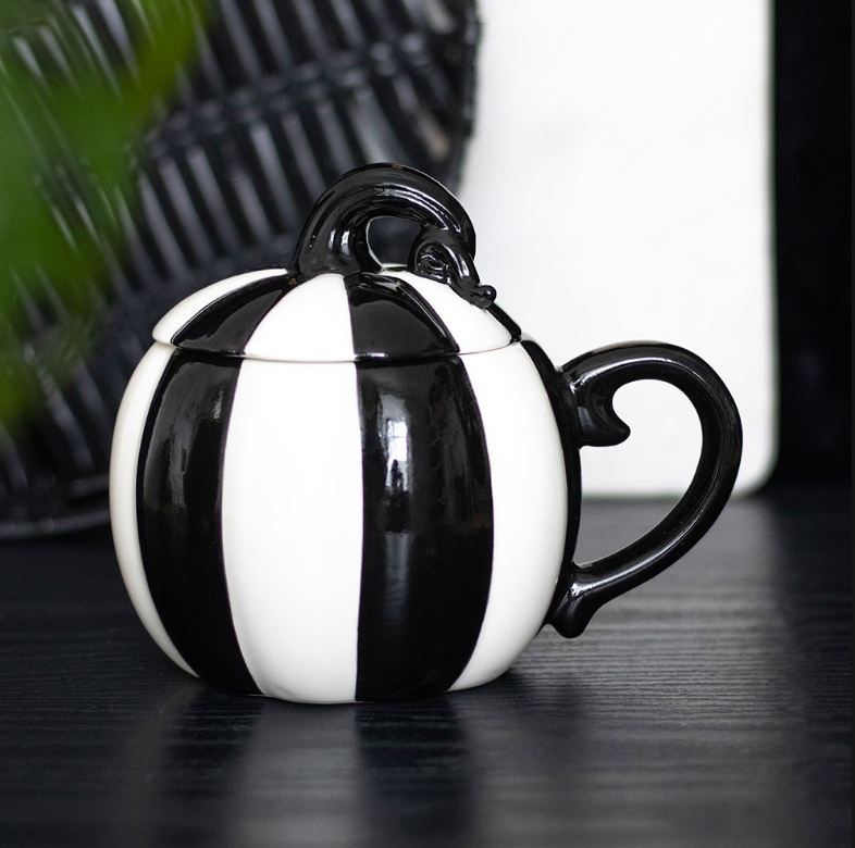 Black-and-white striped pumpkin mug with a matching lid.