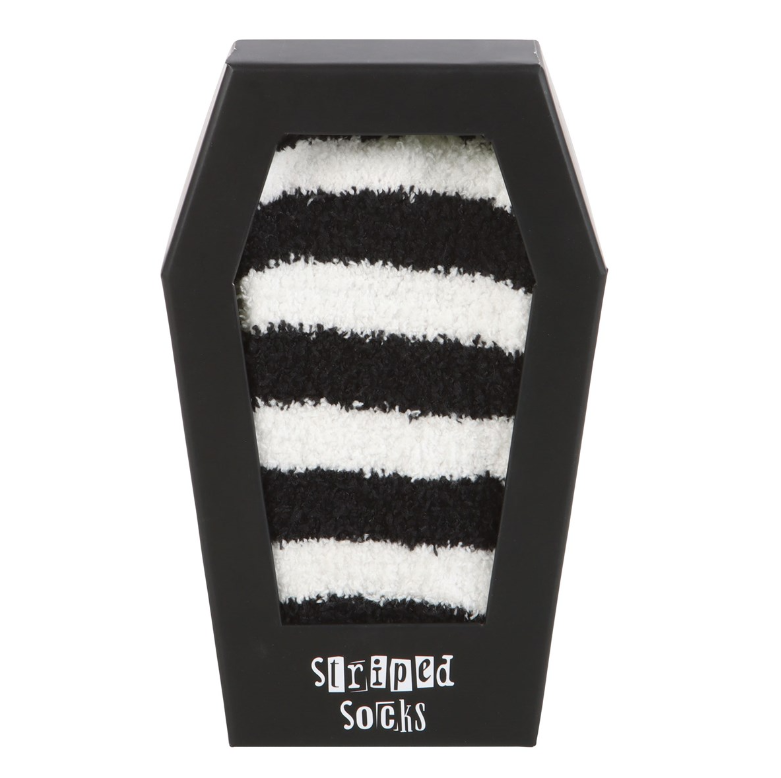 Fluffy black and white striped socks in a coffin-shaped gift box