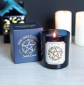 Smoky Amber and Vanilla Solstice Wreath scented candle in glossy navy glass jar with matching navy gift box showing pentagram wreath design