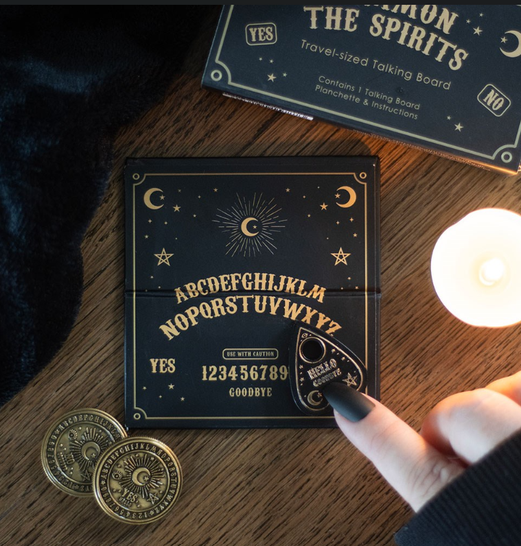 Mini black and gold ouija talking board and teardrop planchette inside open matchbox-style gift box