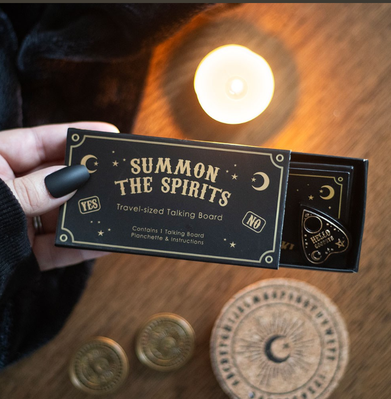 Mini black and gold ouija talking board and teardrop planchette inside open matchbox-style gift box