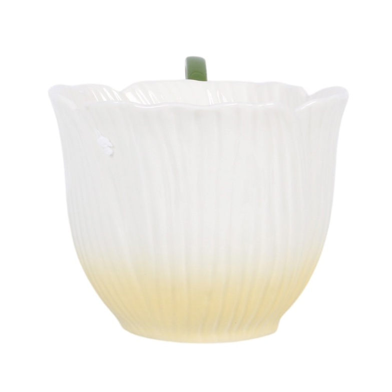 Flower-shaped ceramic teacup with green fairy wing handle.