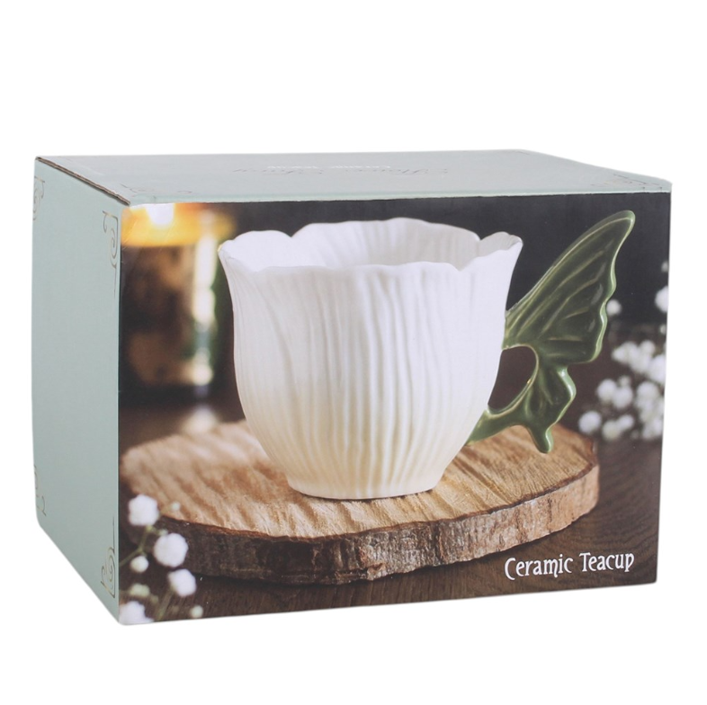Flower-shaped ceramic teacup with green fairy wing handle.