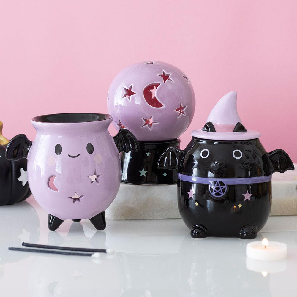 Pastel bat cauldron oil burner with bat wings and moon star cut-out details